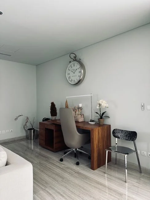A couple enjoys settling into a new home, surrounded by boxes and minimalist decor.